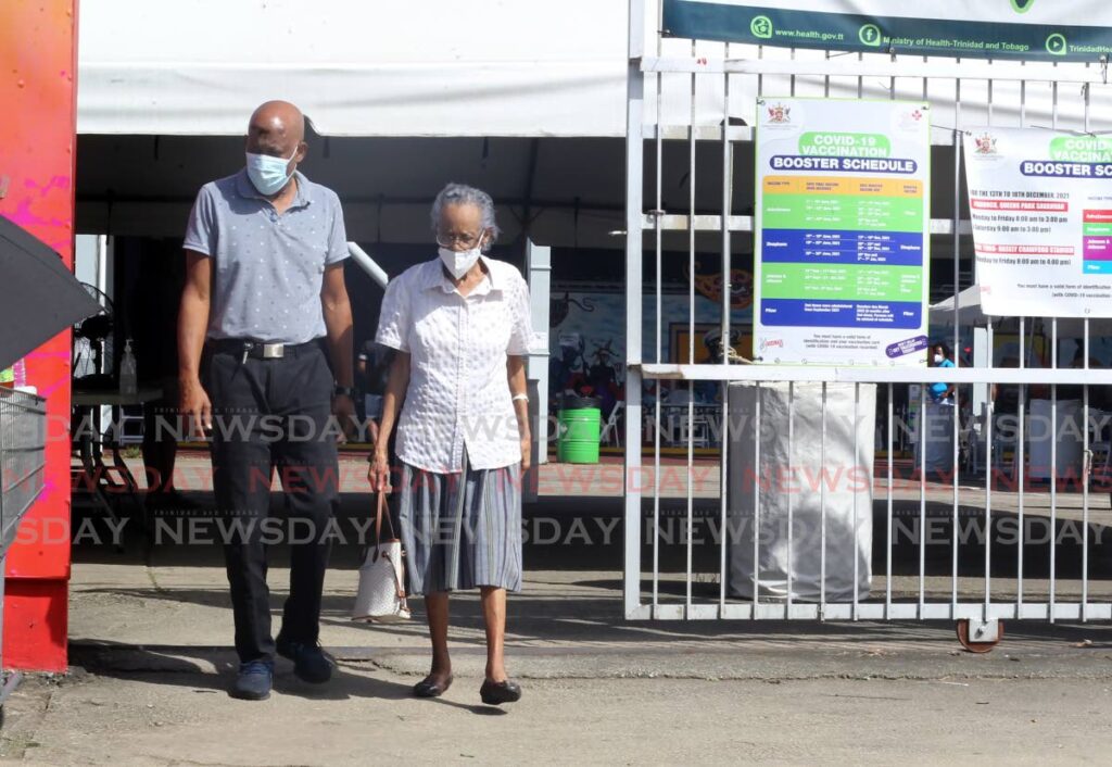 An elderly couple leaves after receiving their third dose,
Low participation from persons which to be vaccinated despite the alarm raised by the new omicron covid variant and a record daily deaths total of 32 persons,
The Paddock of the Queen's Park Savannah, Port of Spain. - Photo by Roger Jacob
