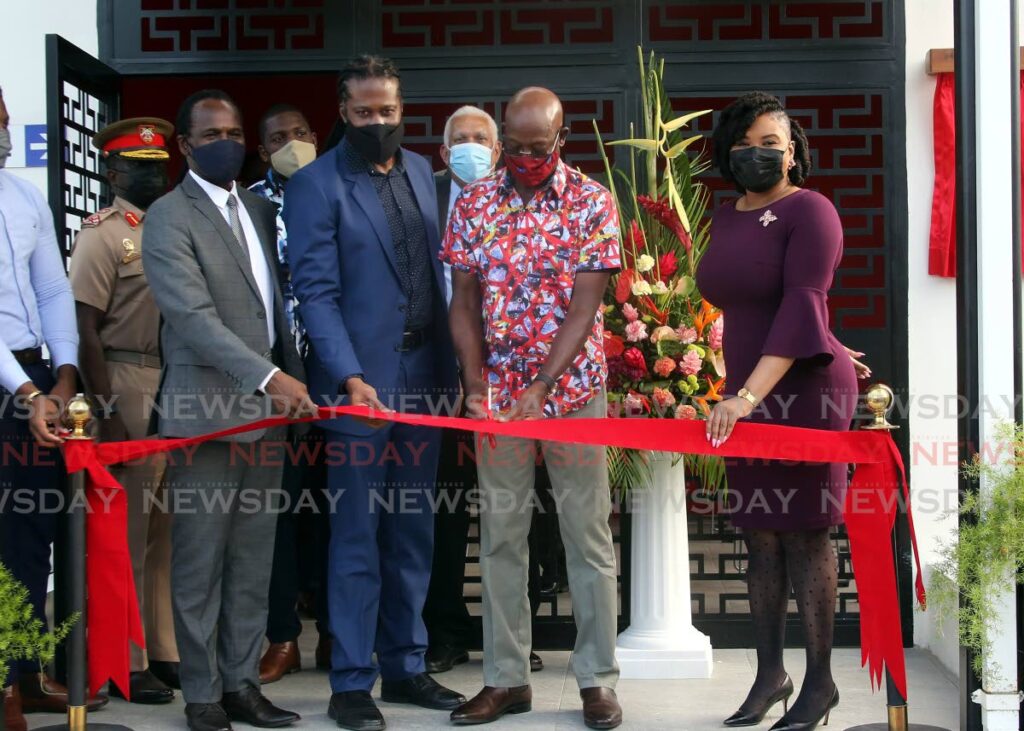 Prime Minister Dr Keith Rowley, second from right, cuts the ribbon to officially open the Morvant  Community Swimming Pool, Cedarwood Street , Morvant, on Thursday. With him, from left, are National Security Minister Fitzgerald Hinds, MP Adrian Leonce and Sports Minister Shamfa Cudjoe. - Sureash Cholai