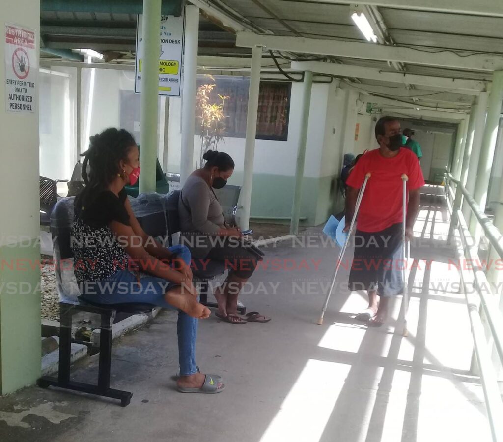 File photo of a patient leaving a ward while others wait for attention at the Sangre Grande Hospital. - Photo by Angelo Marcelle