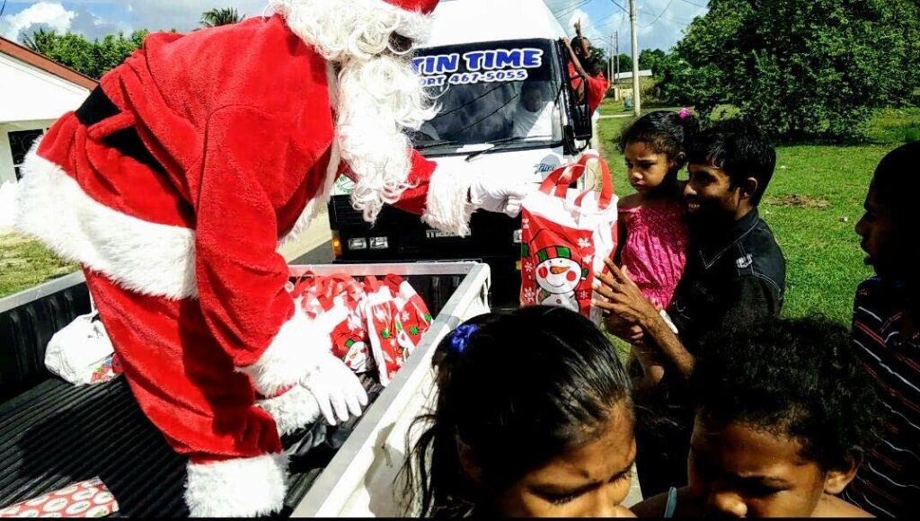 Santa Claus distributes gifts during the Sou Sou Lands Xmas drive in association with the Chaguanas Chamber of Industry and Commerce in 2016. - 