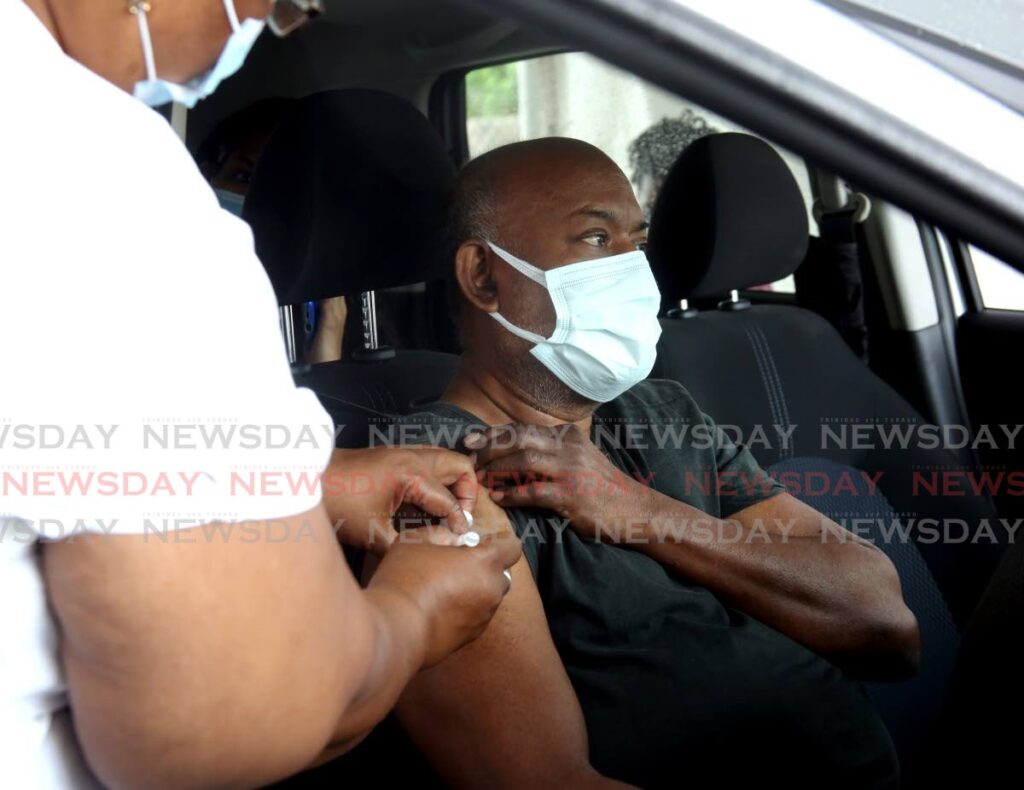 SHOT IN THE ARM: Premnath Ramkissoon receives his booster shot on Tuesday at the Hasely Crawford Stadium in Mucurapo on Tuesday. Photo by Sureash Cholai- 