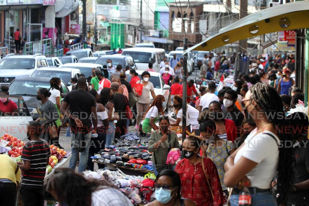 Busy High Street in San Fernando looked jam packed as shoppers attempted to catch bargains for last minute Christmas gift items on Thursday. Photo by Angelo Marcelle