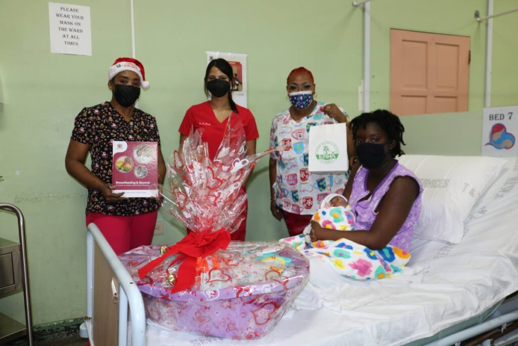 From left, standing, midwife Tushana McClatchie-Ali,  Dr Amy Maraj  and  midwife Amity Baker-David, present tokens to Chelsea Serrena who gave birth on Christmas Day at the Sangre Grande Hospital. - Photo courtesy ERHA