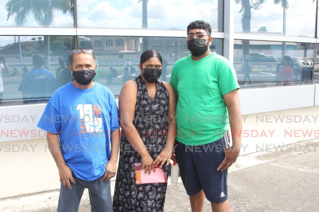 Deonarine Ramadhin and his children, Kevin and Kathlyn visited the SAPA vaccine site San Fernando to receive their vaccine jabs.  Photo by Lincoln Holder