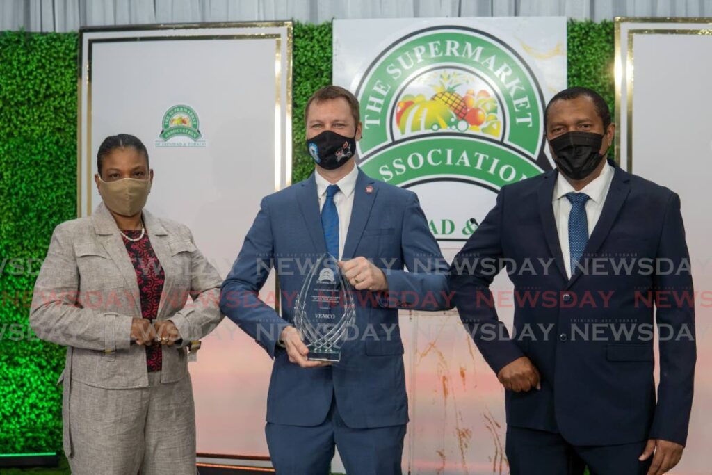 Vemco commercial director Rachel Holder, from left, CEO Chris Alcazar, holding the Supermarket Association Premier Manufacturer of the Year Award, and Cranston Felician, Vemco’s head, procurement and logistics. - 