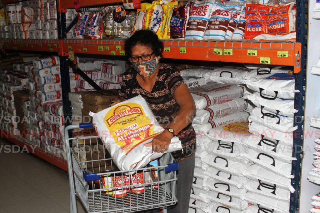 FILE PHOTO: A customer puts a pack of Country Pride Flour at Xtra Foods Supermarket, Xtra Plaza, Chaguanas on Wednesday. - 
