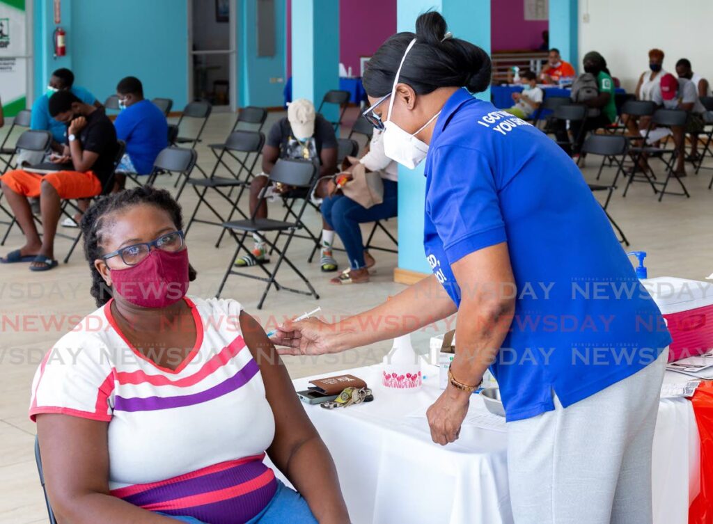 Afea Edwards Peterson of Les Coteaux takes her first shot of the Pfizer vaccine at Port Mall, Scarborough, Wednesday. - David Reid