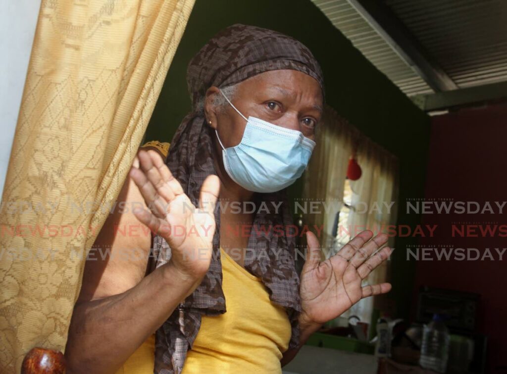 SAVED: Gregoria Edwards talks to Newsday after she and her two grandchildren were saved by their neighbours from their burning home at Faith Avenue, Maturita, Arima, Thursday. Her neighbours were also able to extinguish the blaze saving a large portion of her home. - ROGER JACOB