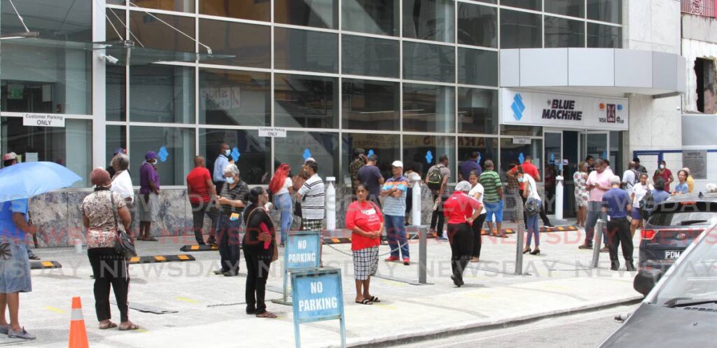 Customers wait in line to enter Republic Bank, Tunapuna. Republic is one bank that is taking steps to provide services to the dispossesed and vulnerable. - File photo/Angelo Marcelle