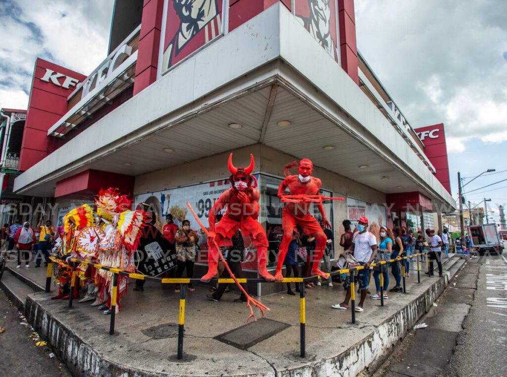 Masqueraders participate in a taste of Carnival event hosted by KFC as a promotion at its Independence Square, Port of Spain branch on February 16, 2021. - File photo/Jeff Mayers