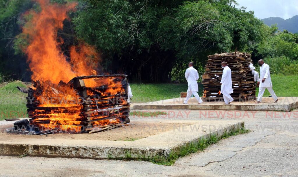 In this file photo, Hindus burn their dead at the Caroni Cremation Site. The public health regulations prohibit open pyre funerals for people who die from covid19.  - 