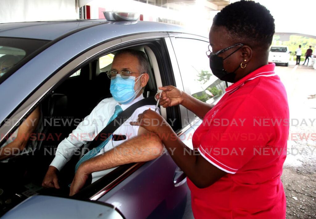 FILE PHOTO: Jeffrey Herrera receives a covid19 booster from nurse Avril Quinton Phillip at the drive-through vaccination facility at the Hasely Crawford Stadium, Port of Spain on December 14, 2021. - SUREASH CHOLAI