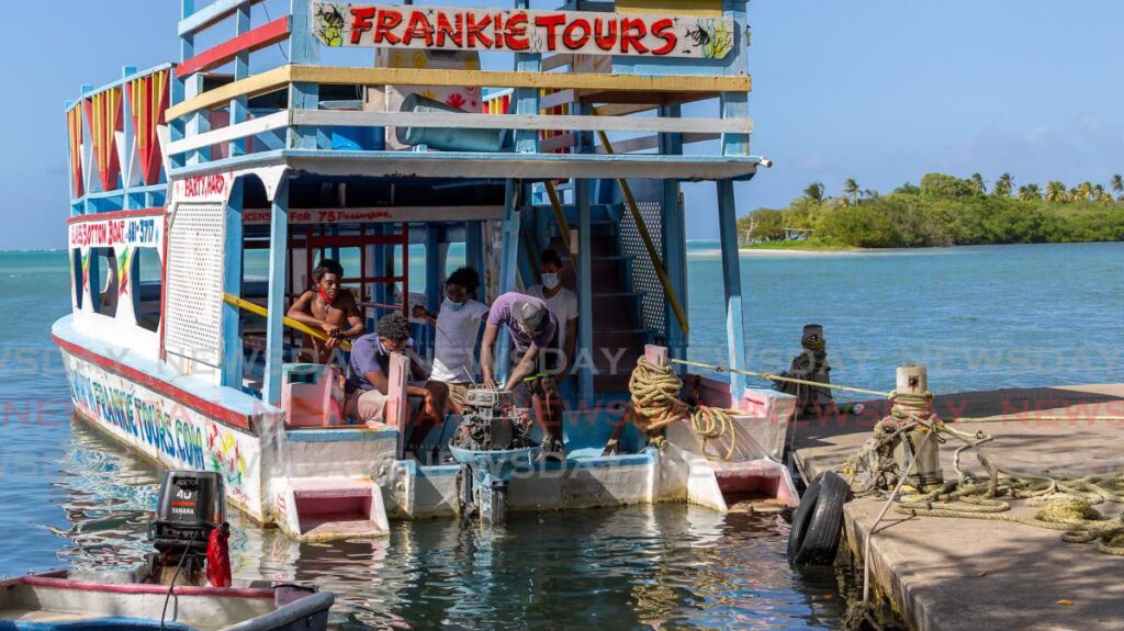 In this file photo, Frankie Tours reef boat workers get the engine ready on Sunday ahead of Monday's reopening of the beaches from 5am to noon. Beaches had been closed since April as a measure to curb the spread of the covid19 virus. - Photo by David Reid