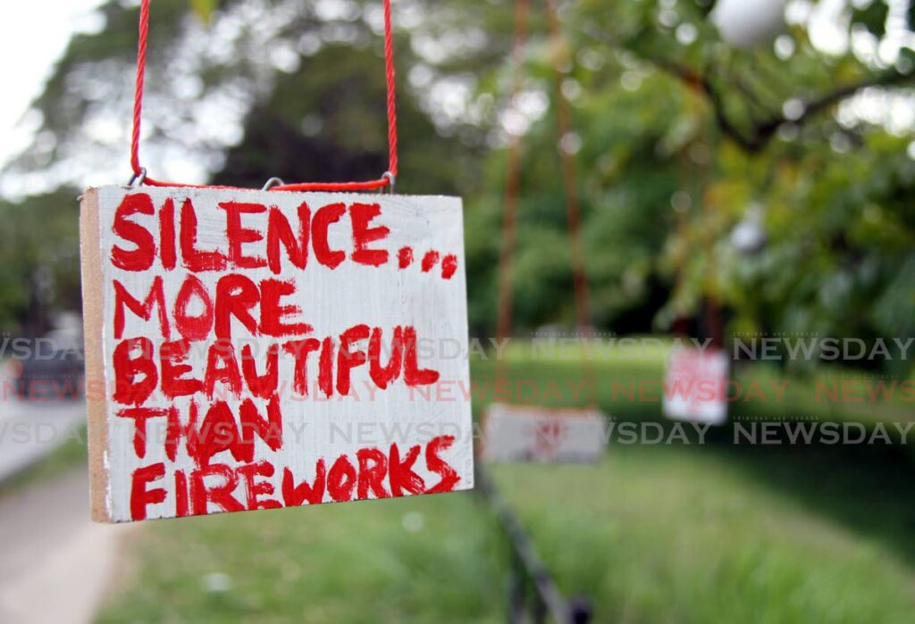 One of the signs placed on a tree around the Queen's Park Savannah, Port of Spain objecting to the use of fireworks during the Christmas holidays.  - Photo by Ayanna Kinsale