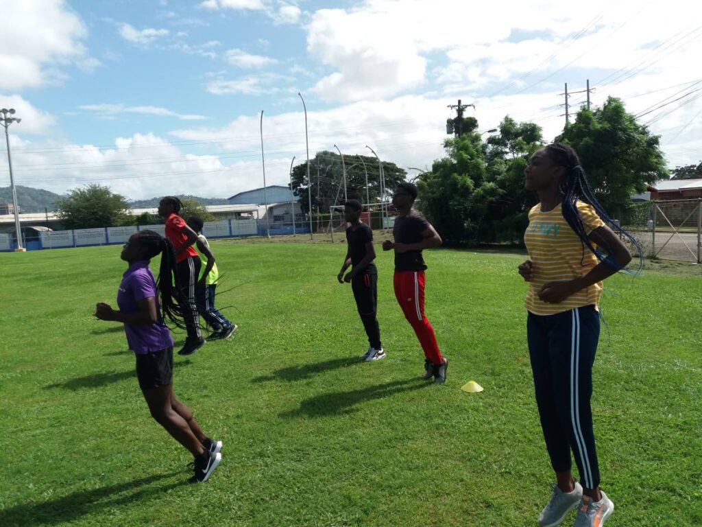 A few athletes from the Mason Hall Police Youth Club engage in warm-up activities at the athletics workshop at the Hasely Crawford Stadium, Mucurapo in December 2021. - 