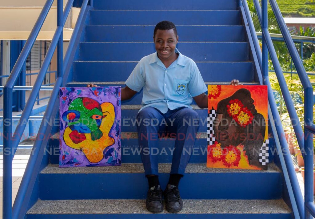 Form four student Israel Melville shows two of his paintings on the steps of Speyside High School on Wednesday.  - Photo by David Reid