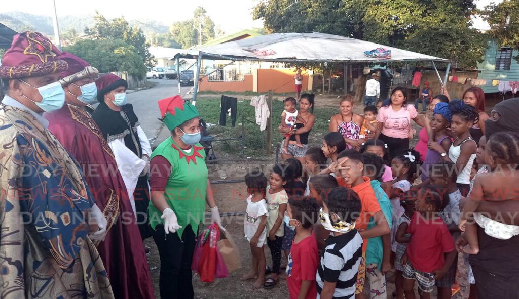 Volunteers dressed as the Three Kings – Melchor, Gaspar and Baltasar – give out gifts to children in a community in east Trinidad.
 - Photo by Grevic Alvarado