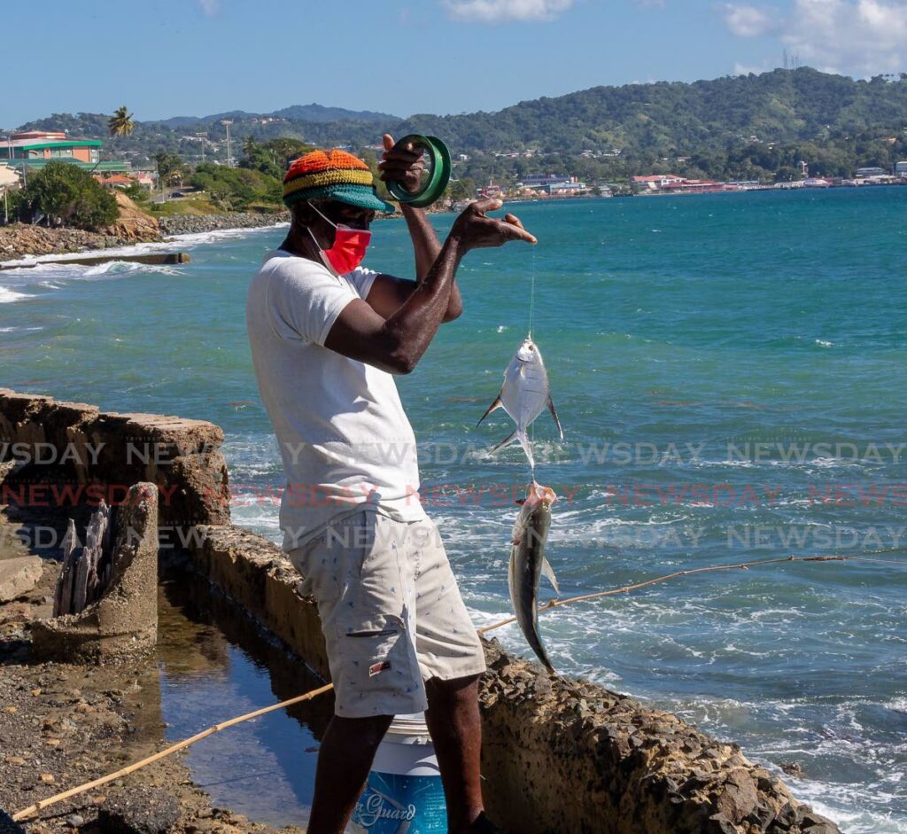 Edward Grant, 67, shows off his catch at Lambeau Bay on January 6. The main attraction of our islands are their authenticity and community feel. - FILE PHOTO/DAVID REID