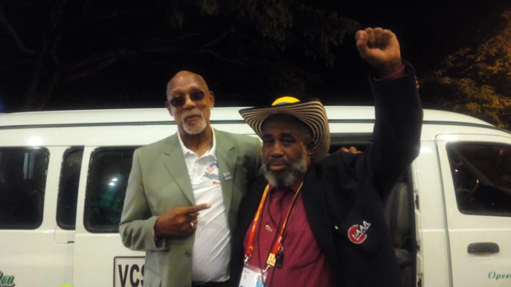 John Andalcio, right, in company with legendary American athlete, John Carlos, at a past track and field meet.  - 