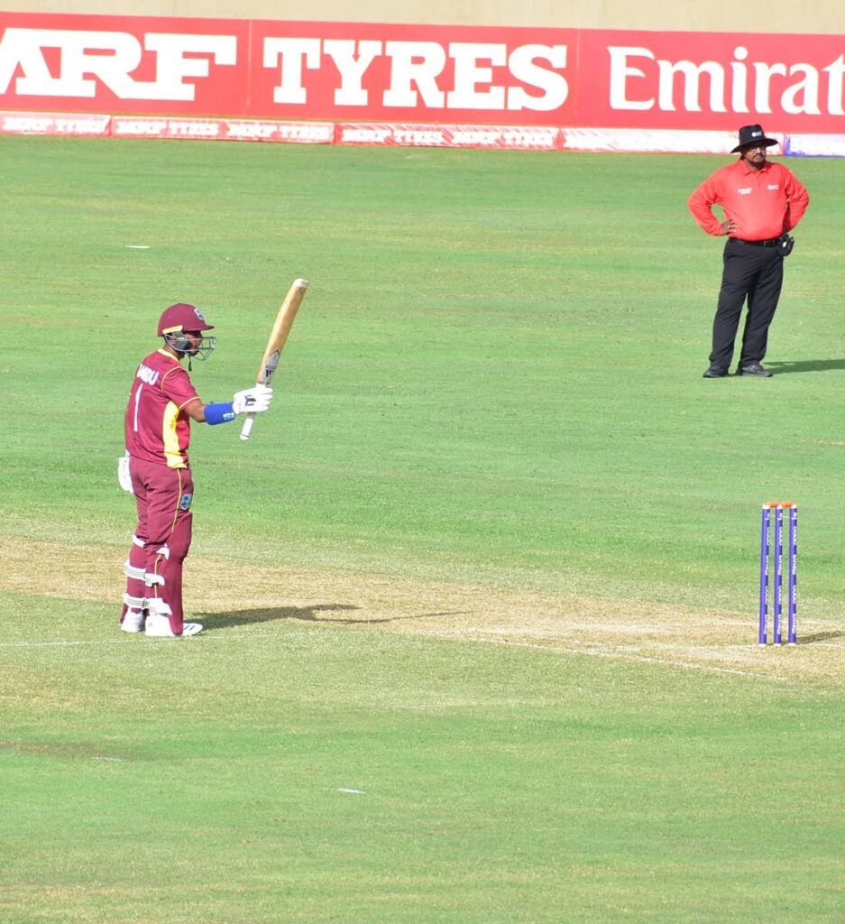 West Indies Under-19 player Matthew Nandu raises his bat after completing his half century against India in an Under-19 World Cup warm-up match against India at Providence, Guyana, on Sunday. PHOTO CWI - CWI
