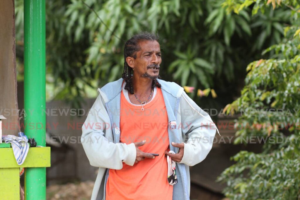 In this January 10 file photo, Anthony Ali Bocas demonstrates where the bullet hit his wife, Dianna Dhanassar, 38, during a shooting on Sunday night in St Ann's Road East, Mayaro. Dianna's son, Jacob Ali Bocas, 14, was also wounded and his cousin Ryan Heeralal died. - Photo by Marvin Hamilton