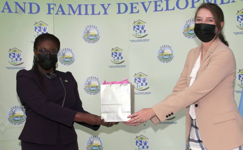 British High Commissioner Harriet Cross, right, presents a gift to Secretary of Health, Wellness and Social Protection Dr Faith BYisrael during a courtesy visit at the division in Scarborough on Tuesday.  - THA