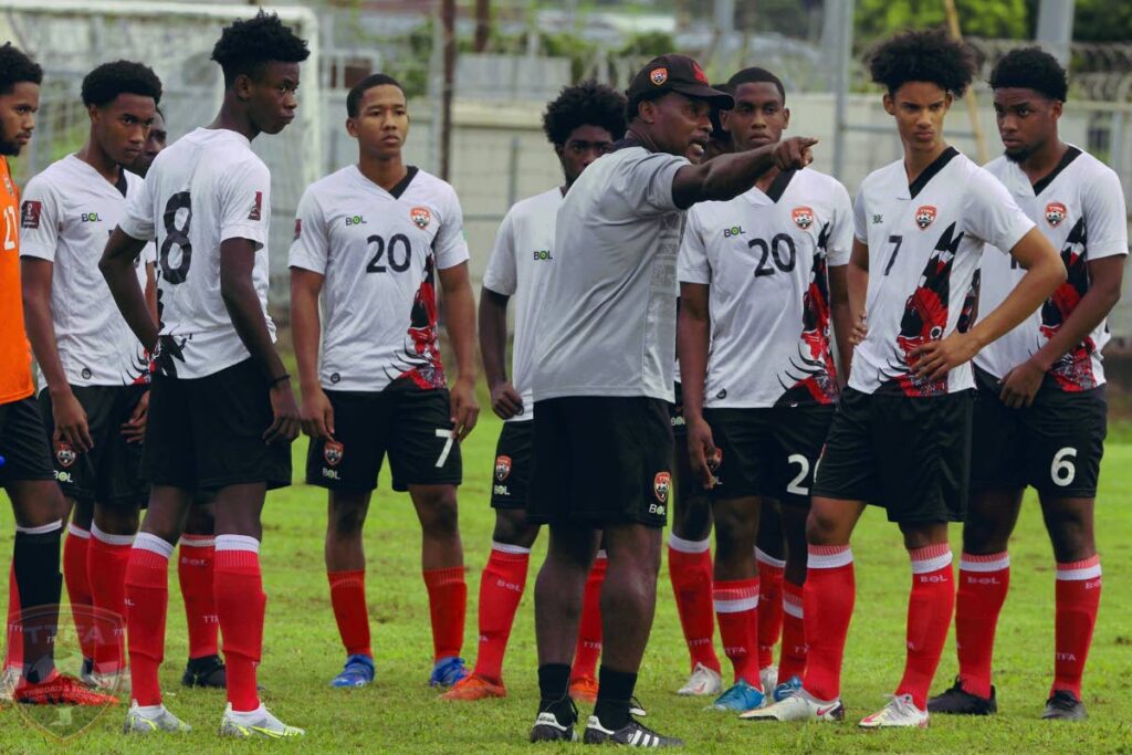 Trinidad and Tobago men's Under-20 assistant coach Reynold Carrington speaks to his players during a training session at the Hasely Crawford Stadium training grounds in Port of Spain, on Wednesday. PHOTO BY TTFA - TTFA