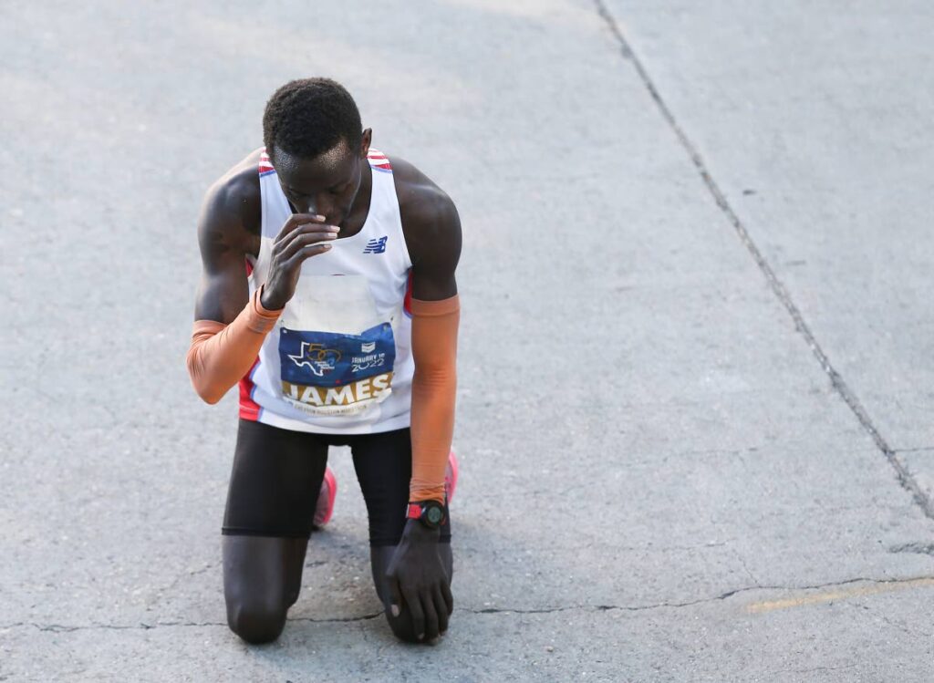 In this photo taken on Sunday, Kenya’s James Ngandu pauses after winning the 50th Chevron Houston Marathon. Ngandu finished
the race at 2:11:03. (via AP) - 