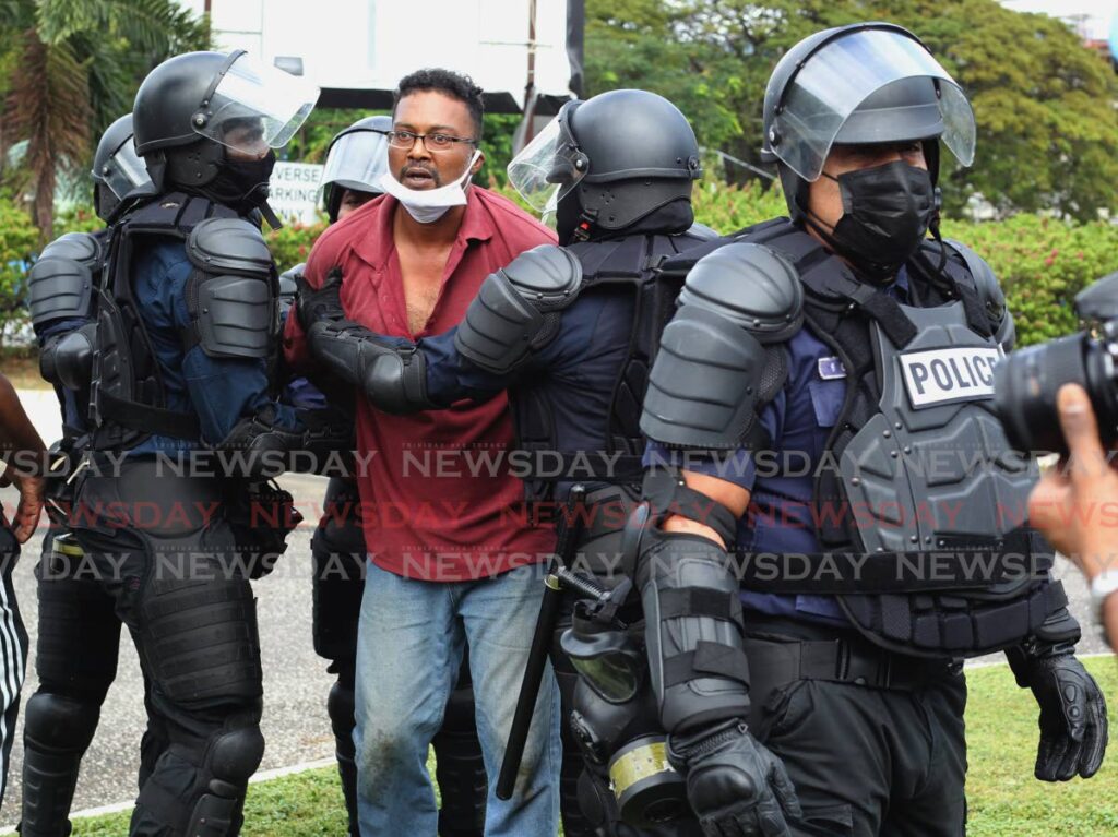 A man is arrested by police at the First Wave Movement's 