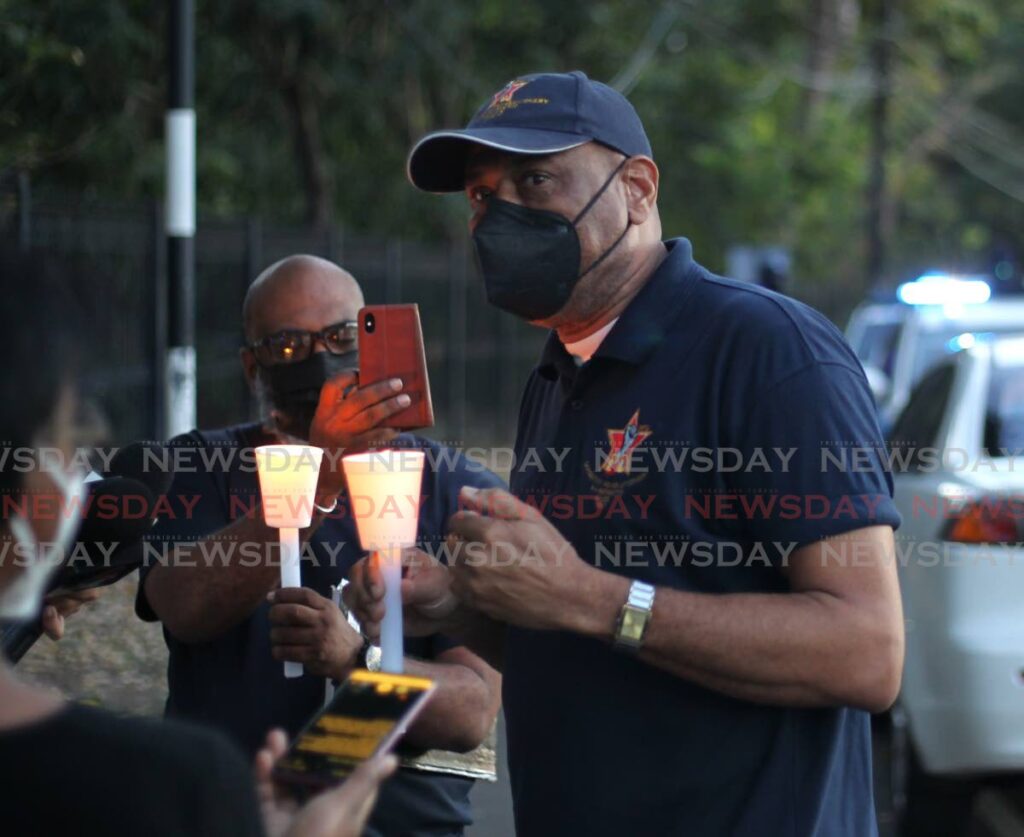 JTUM head Ancel Roget speaks to reporters on Sunday evening during a candlelight vigil outside the Prime Minister's offical residence in St Ann's. PHOTO BY ROGER JACOB - 