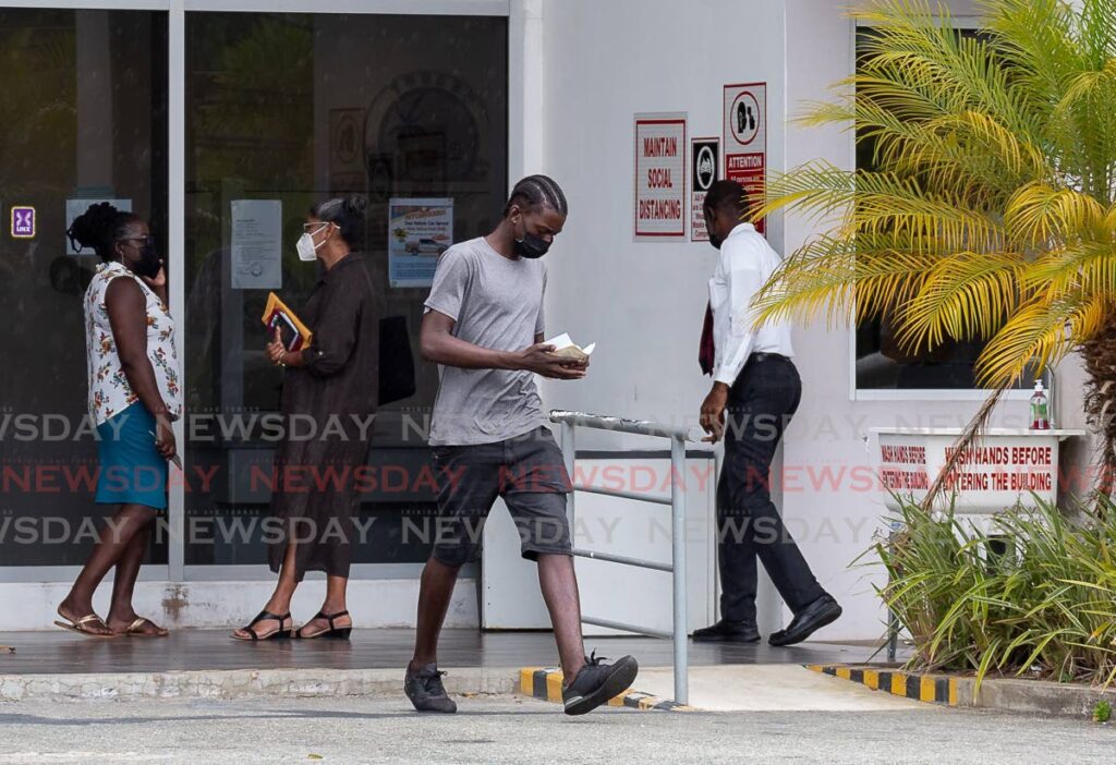 A man wearing a short pants exits Licensing Office, Shirvan Road, Tobago on Tuesday. - David Reid
