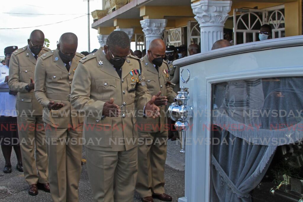 Police officers pay their respect to late acting Snr Supt Terrence Nobbee at his funeral at the First Church of the Open Bible, Ruth Avenue in San Fernando on Wednesday. - Marvin Hamilton