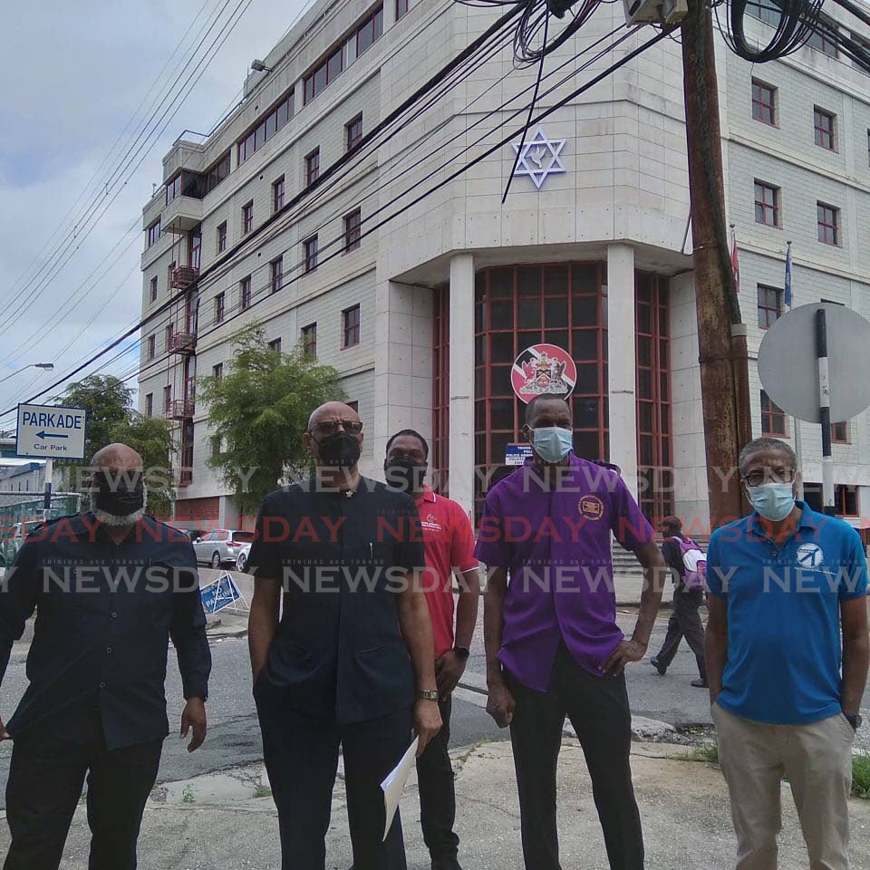President general of the Joint Trade Union Movement (JTUM) Ancel Roget, second from left, stands with other union leaders outside the Police Administration Building, Sackville Street, Port of Spain, on Friday. - Photo Shane Superville