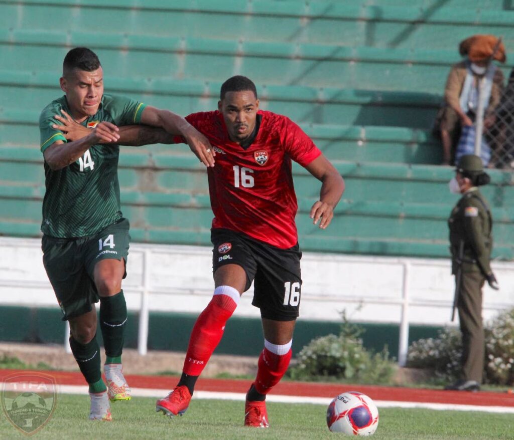 Trinidad and Tobago men's team defender Alvin Jones (right) battles for the ball with Bolivia's Moisés Villaroel during the friendly football international between Trinidad and Tobago and Bolivia in Sucre, Bolivia on Friday. PHOTO COURTESY TTFA. - 