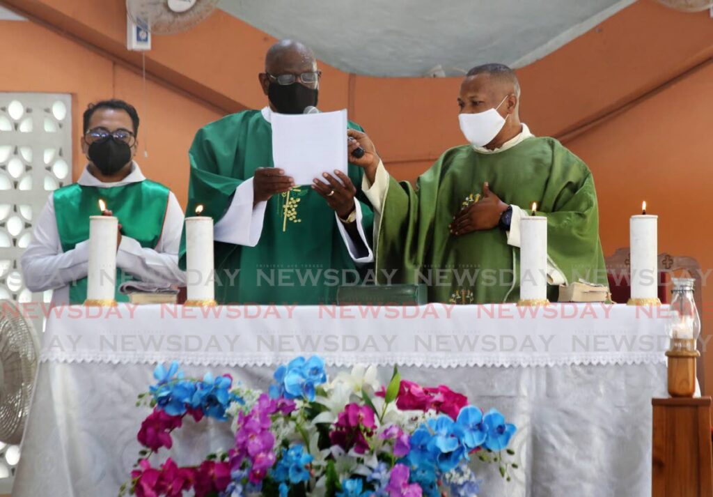 Newly-ordained deacon Justice Malcolm Holdip celebrates mass with Fr Martin Ezesigwe at the Church of the Holy Family, Mt Lambert on Sunday. - SUREASH CHOLAI