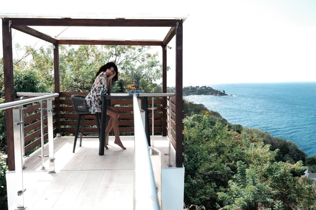 A guest enjoys the breathtaking view at Height of Being, Arnos Vale, Tobago. - 