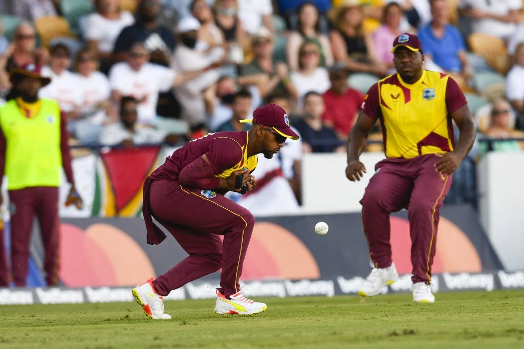 Nicholas Pooran (L) of West Indies drops a hit by Moeen Ali of England during the 2nd T20I at Kensington Oval, Bridgetown, Barbados, on Sunday. - RANDY BROOKS