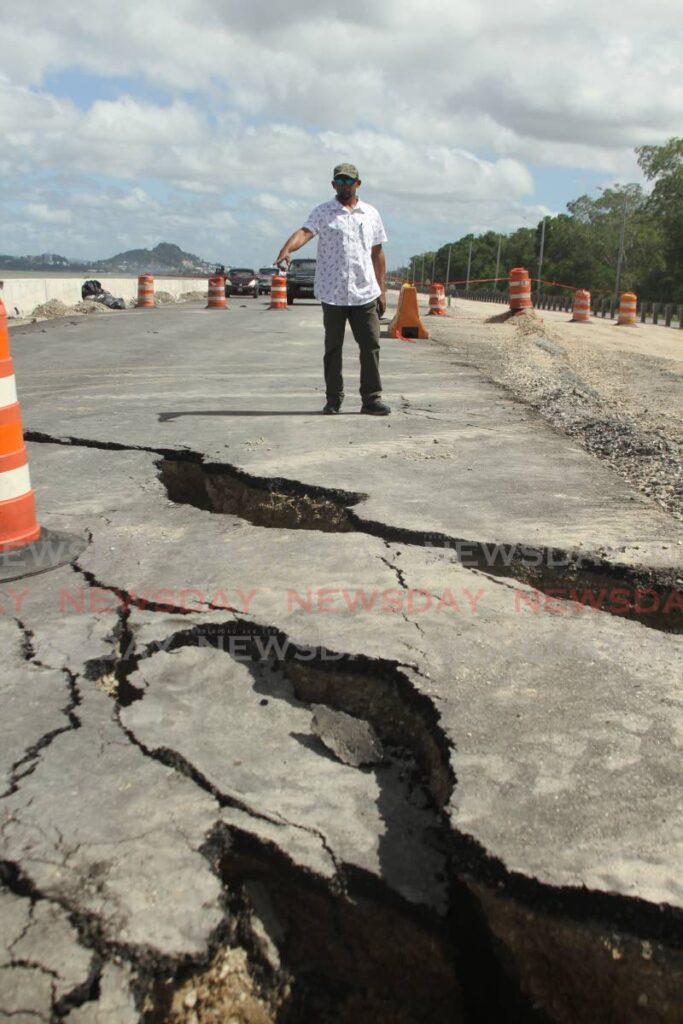 President of the South Oropouche Riverine Flood Action Group, Edward Moodie points to cracks on the Point Fortin to San Fernando extension of the Solomon Hoychoy Highway (Mosquito Creek segment). - Photo by Marvin Hamilton