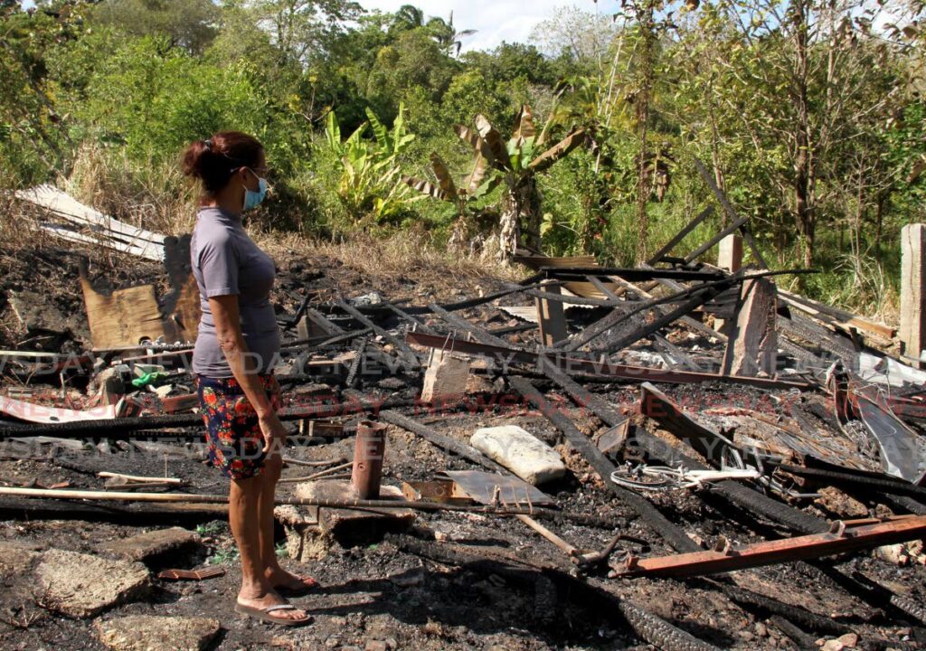 On Monday, Rajandaye Mohammed looks at the ruins of her home at Caratal Road Section 1, Bonne Aventure, Gasparillo, which was burnt to the ground on Sunday. - AYANNA KINSALE