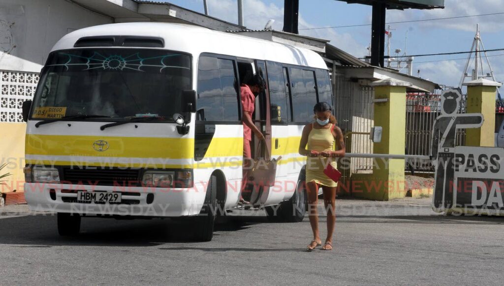 A Diego Martin Maxi Taxi allows passengers to disembark at the Port of Spain hub on Monday. The fare was increased by one dollar on Monday. - Photo by Angelo Marcelle