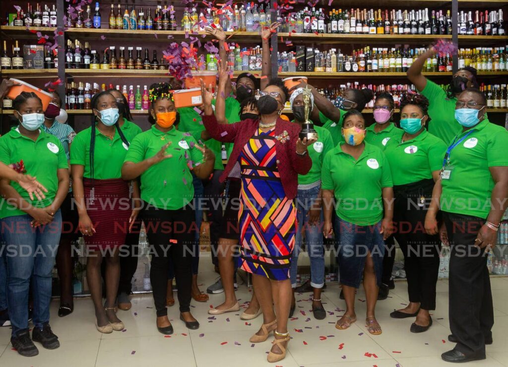 Melony Hunte, front, general manager and director, Viewport Supermarket, celebrates with staff after collecting the Supermarket Association of TT's People's Choice (Tobago) award at the Scarborough branch last Monday. - David Reid