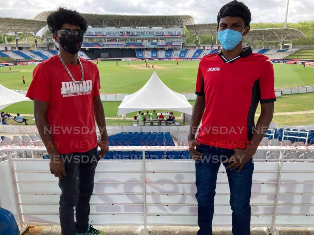 Siblings Saiff, 17, left, and Kavinash Ali, 21, took a day off from their respective duties, on Tuesday, to view an U19 World Cup match at Brian Lara Cricket Academy in Tarouba. On Monday night, SporTT announced that fully vaccinated fans would be allowed free entry to the remainder of U19 World Cup matches in Trinidad.  - JONATHAN RAMNANANSINGH