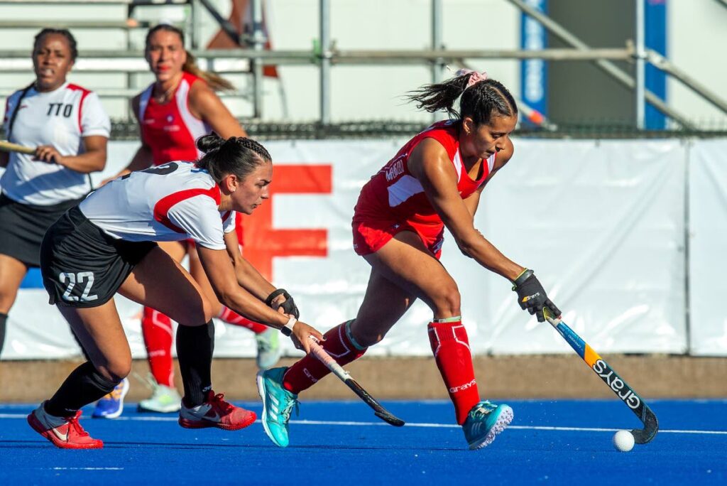 Trinidad and Tobago's Samantha Olton (22) defends as Chile's Francisca Tala (14) controls the ball during the Pan American Cup match, on Tuesday, in Santiago, Chile. TT lost 11-0. - via Pan American Hockey Federation