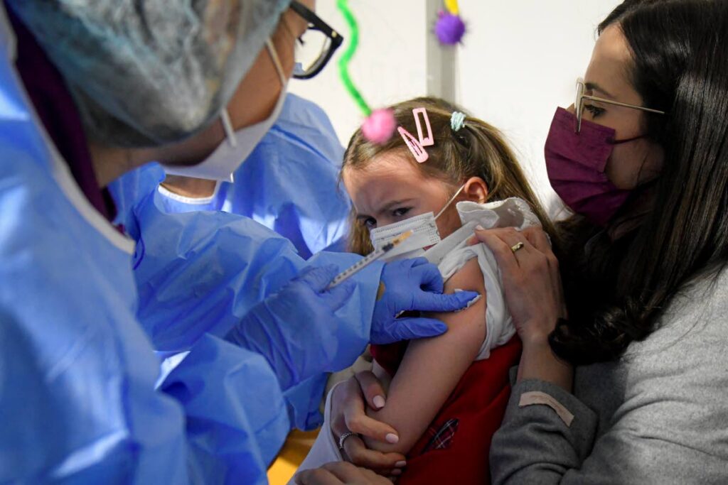 Patricia, eight, grimaces after getting her first dose of the Pfizer-BioNTech covid19 vaccine for children 5-11, at a vaccination centre in Bucharest, Romania. - AP Photo 