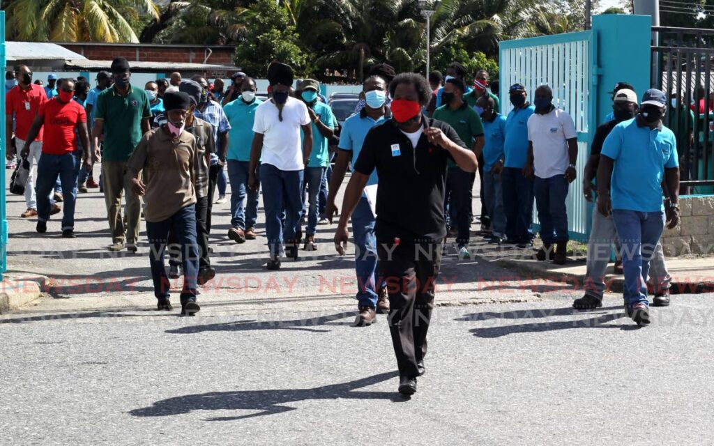 Russell Mohammed Secretary of the WASA Worker Section (NUGFWU) leads the employees to the main entrance of WASA's headquarters, Farm Road, St Joseph, on Wednesday as workers protest in attempt to get a meeting with the authority's managment. - ROGER JACOB