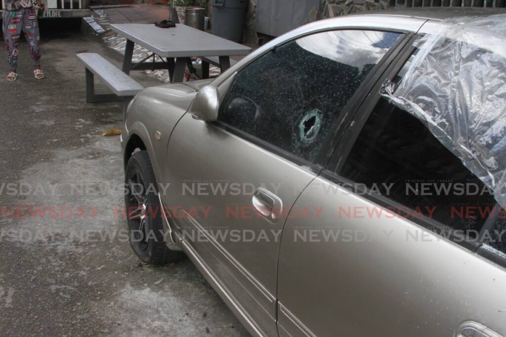 One of two cars that were hit with bullets on Thursday night at Temple Street, Arima. - Photo by Angelo Marcelle