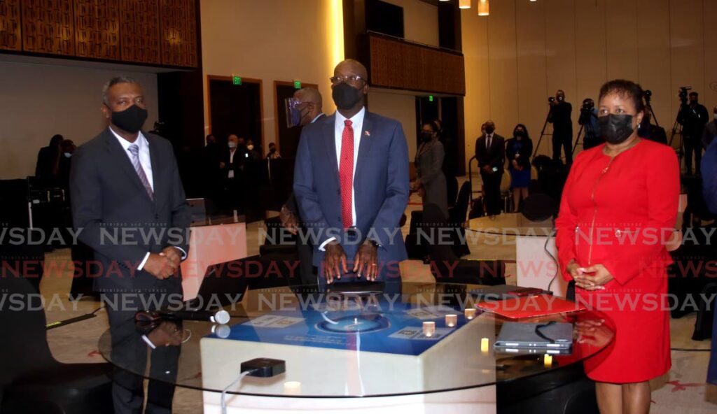 Prime Minister Dr Keith Rowley is flanked by Minister of Digital Transformation Hassel Bacchus and Minister of Public Administration Allyson West at the Hyatt on Monday. - SUREASH CHOLAI