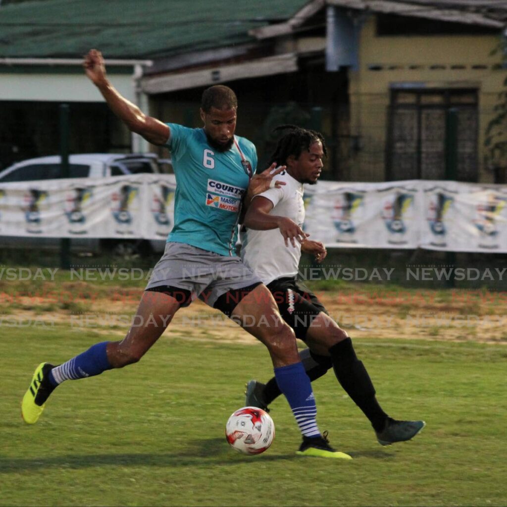 In this September 2019 file photo, Morvant Caledonia AIA defender Radanfah Abu Bakr (left) screens off Kishon Hackshaw of Terminix La Horquetta Rangers, during a match in Division One of the Ascension Invitational Football Tournament, at the La Horquetta Recreation Ground, Arima. The league expects to resume in March pending approval. - 