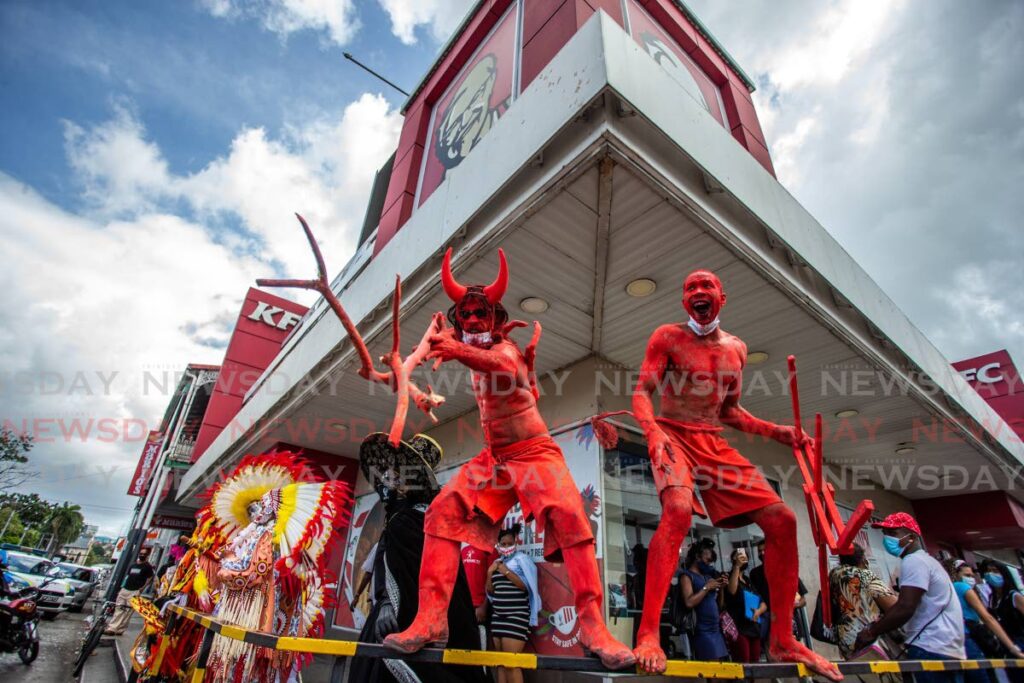In this February 16, 2021 file photo traditional mas characters entertain the public outside KFC Independence Square, Port of Spain as a tribute to Carnival which did not take place owing to the covid19 pandemic. - JEFF K MAYERS