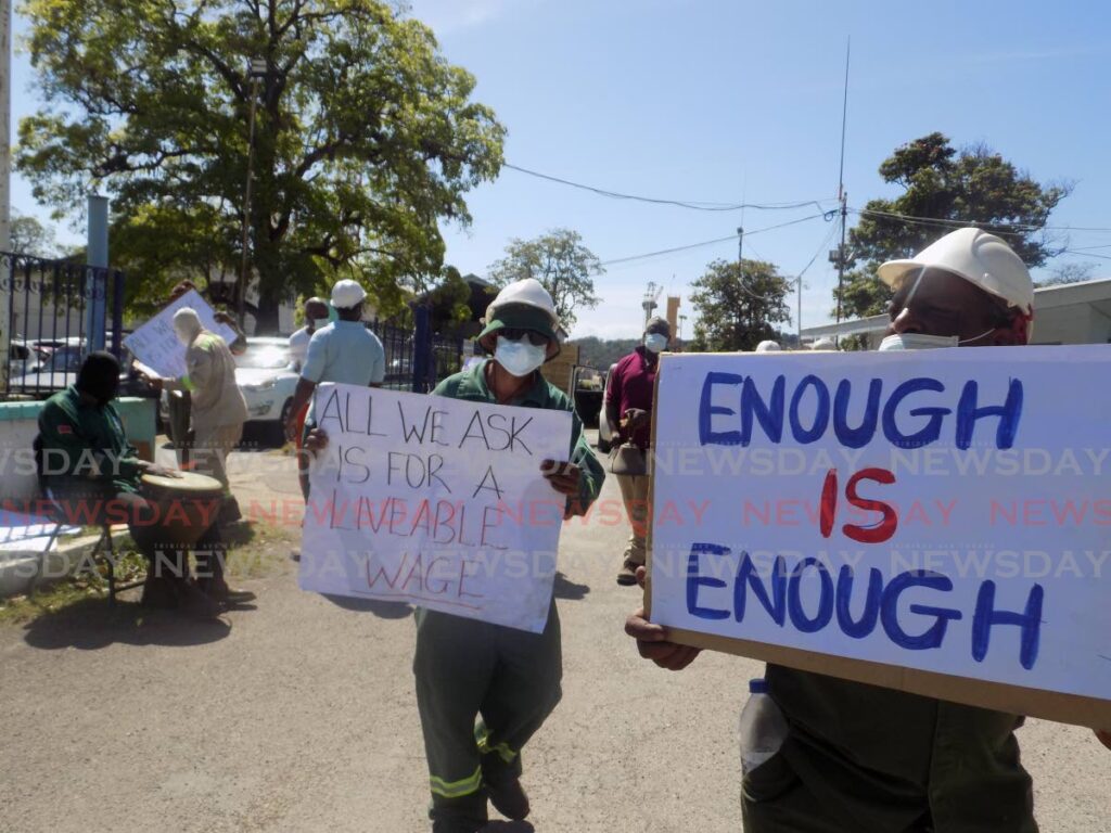In this photo taken in January, workers from the National Marine and Maintenance Services Co Ltd (formerly CL Marine) hold signs protesting low wages during a demonstration at the company's Chaguaramas dock. - FILE PHOTO/SHANE SUPERVILLE